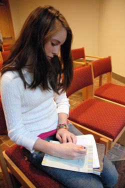 St. Thomas Aquinas parishioner Katie Quigley of Indianapolis writes a letter to Indiana Sen. Evan Bayh asking for his support of global hunger relief legislation during Bread for the World’s Offering of Letters on Oct. 26 at the Indianapolis North Deanery church. St. Thomas Aquinas parishioners and members of several Protestant Churches in Indianapolis will be featured in the organization’s 2009 educational video, which will be distributed to thousands of churches in the U.S., sent to every member of Congress and posted on Bread for the World’s Web site. (Photo by Mary Ann Wyand) 
