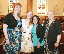 Three Providence Volunteer Ministers are giving a year of service at St. Ann Clinic in Terre Haute. Arrianne Whittaker, from left, Kate Sullivan and Nancy Morales pose for a picture with Providence Sister Lawrence Ann Liston, clinic administrator, in the Church of the Immaculate Conception at Saint Mary-of-the-Woods. (Submitted photo) 