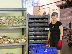 Society of St. Vincent de Paul volunteer Barbara Sherrow, a member of St. Jude Parish in Indianapolis, works the bread portion of the society’s Client Choice Food Pantry in Indianapolis. (Submitted photo) 
