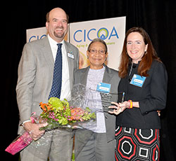 JoAnn Fowler Combs, center, receives the Central Indiana Council on Aging, Inc. (CICOA) Caregiver of the Year award from Orion Bell IV, left, CICOA’s president and CEO, and Mary Beth Tuohy, chair of CICOA’s board of directors, at a breakfast held at the Ritz Charles in Carmel on April 18. (Submitted photo)