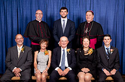 Catholic Charities Indianapolis presented six individuals with Spirit of Service Awards during an April 30 dinner in Indianapolis. Award recipients, seated from left, are Larry Heil, Mary Ann Browning, Art Berkemeier, Ann Berkemeier and Billy Cross. Standing, from left, are Bishop Christopher J. Coyne, keynote speaker Andrew Luck and Archbishop Joseph W. Tobin. Michael Browning was also honored, but he was unable to attend the event because of another engagement. (Submitted photo by Rich Clark)