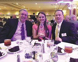 St. Elizabeth Catholic Charities of New Albany’s immediate past advisory council chairman Ken Johnson, left, social services director Leslea Townsend Cronin and agency director Mark Casper pose with the Non-Profit of the Year Award that their organization won at the One Southern Indiana annual meeting on Aug. 16. (Submitted photo)