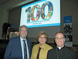 The archdiocese’s Catholic Charities executive director David Bethuram, left, Catholic Charities USA president and chief executive officer Dominican Sister Donna Markham, and Archbishop Charles C. Thompson are all smiles in the Archbishop Edward T. O’Meara Catholic Center in Indianapolis after the 100th anniversary celebration dinner on Nov. 20 for Catholic Charities in the archdiocese. (Photo by John Shaughnessy) 