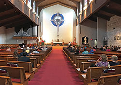 Worshipers take part in a Mass celebrated on July 20, 2017, for members of Legatus, an organization for Catholic business leaders, at St. Luke the Evangelist Church in Indianapolis. On May 8, Archbishop Charles C. Thompson announced a plan to allow for the phased and safe reopening of churches and the celebration of the Mass and other sacraments across central and southern Indiana. When the celebration of Mass resumes in the archdiocese, seating will be limited in a continued effort to help slow the spread of the coronavirus. (File submitted photo by Katie Rutter)