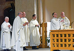 Archbishop Charles C. Thompson elevates the Eucharst at SS. Peter and Paul Cathedral in Indianapolis on Sept. 23 during a special Mass for those who contributed $1,500 or more to this year’s annual United Catholic Appeal. Concelebrating with the archbishop are Msgr. William F. Stumpf, second from left, Father Patrick Beidelman, Father Eric Augenstein and Msgr. Joseph Schaedel. Assisting with the Mass is Deacon Stephen Hodges, left. (Photo by Natalie Hoefer)