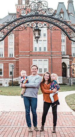 Seth and Chelsea Monholand pose for a family photo with their children, Theodore and Cecelia, on the campus of DePauw University in Greencastle where the couple work together to bring college students closer to God. (Submitted photo)