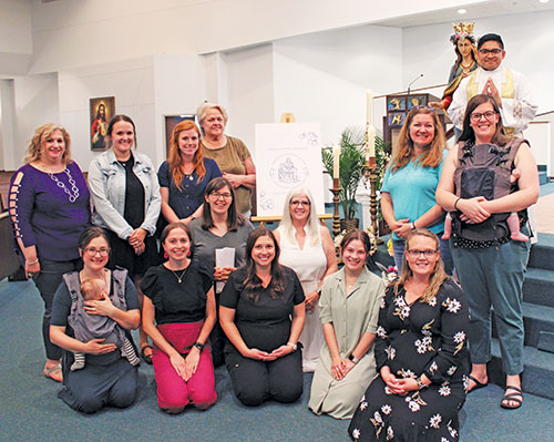 Women who restarted a local chapter of the Confraternity of Christian Mothers at Our Lady of the Greenwood Parish in Greenwood pose in the parish church on May 13 after receiving a blessing from Father Jose Neri, the parish’s parochial vicar. (Photo by Jennifer Lindberg)