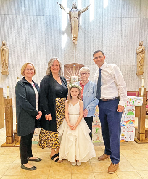 After Clara Borgert received her first Communion at St. Pius X Church in Indianapolis on May 20, she posed for a photo with her grandmother, Connie Schneider, second from right, and her three godparents, Carol Untrauer, left, Annette Rhine and Mark Borgert.  (Submitted photo)