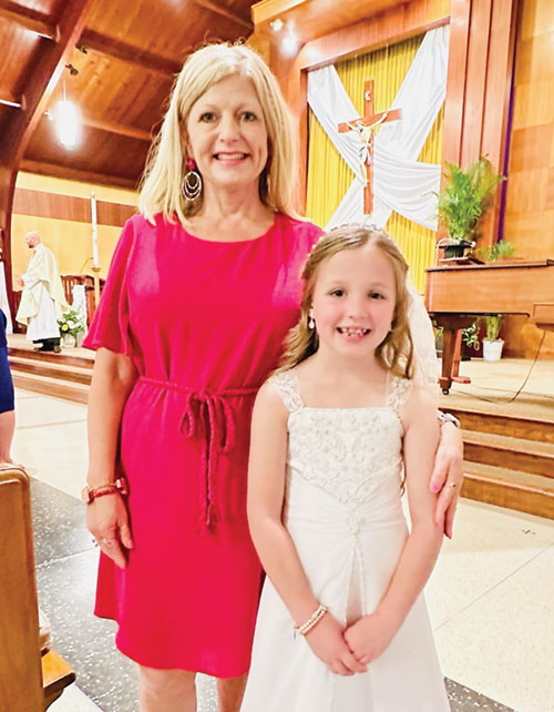Beth Summers, a second-grade teacher at Holy Family School in New Albany, poses for a photo with Hadleigh Stocksdale, one of the students she helped prepare to receive the sacrament of the Eucharist on April 27 in the parish church. (Submitted photo)