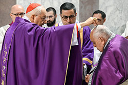 Cardinal Mauro Piacenza, head of the Apostolic Penitentiary, sprinkles ashes on Pope Francis' head during Ash Wednesday Mass at the Basilica of Santa Sabina in Rome Feb. 14, 2024. (CNS photo/Vatican Media)