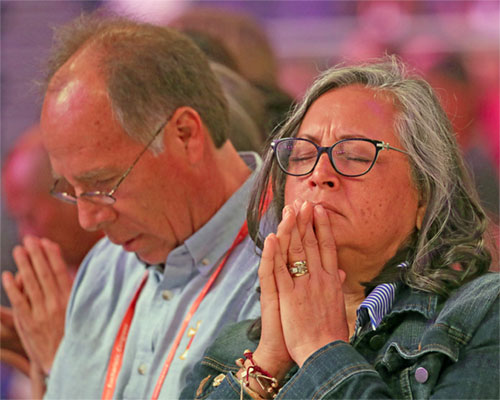 Pilgrims pray during a July 19, 2024, Encounter impact session at Lucas Oil Stadium during the National Eucharistic Congress in Indianapolis. (OSV News photo/Bob Roller)