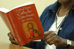 Woman holding U.S. Adult Catechism